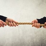 Tug Of War. Hands Pulling Rope To Opposite Sides